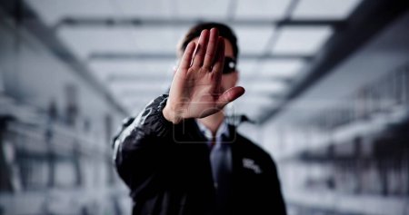 Photo for Security Guard Officer Making Stop Gesture In Office - Royalty Free Image