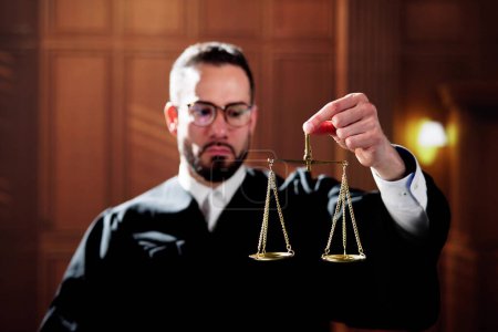 Photo for Judge In Courtroom Holding Justice Scales. Government Litigation - Royalty Free Image