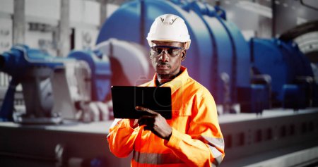 Téléchargez les photos : African Engineer Man Checking Industrial Facility. Inspection d'Osha - en image libre de droit