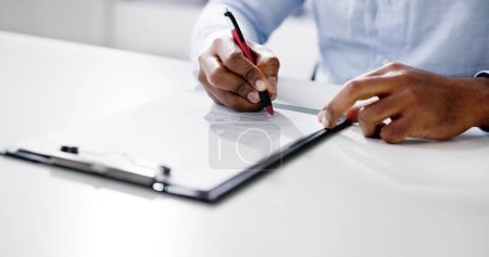 Photo for Agreement Form Signature. Hand Signing Paper Using Pen - Royalty Free Image