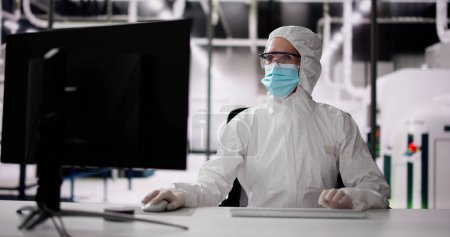 Photo for Sterile Semiconductor Manufacturing Factory And Worker In Coverall - Royalty Free Image