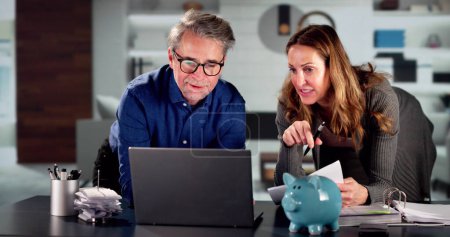 Photo for Couple Doing Taxes And Family Budget On Computer - Royalty Free Image