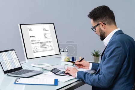 Photo for Accountant using computer to manage invoices and account - Royalty Free Image