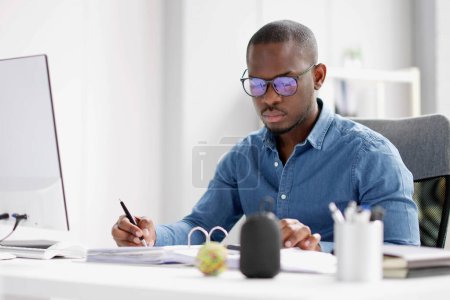 African accountant using calculator for business accounting account