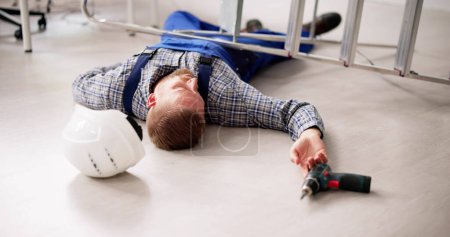 Photo for Handyman Injured After Falling From Ladder. Work Accident - Royalty Free Image