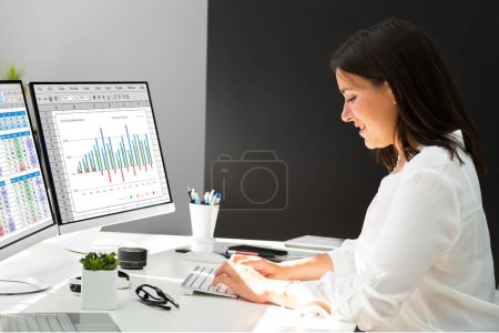 Photo for Two women analyzing data on computer desktop spreadsheet - Royalty Free Image