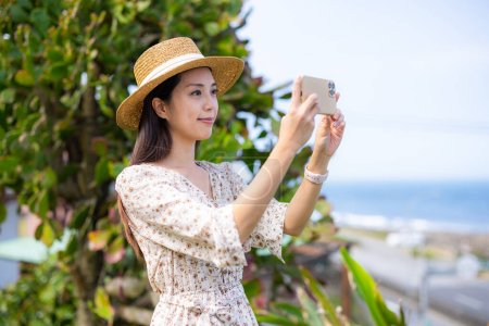 Photo for Tourist woman use mobile phone to take photo - Royalty Free Image