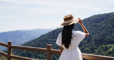 Foto de Mujer de pie en la terraza y mirar a la montaña - Imagen libre de derechos