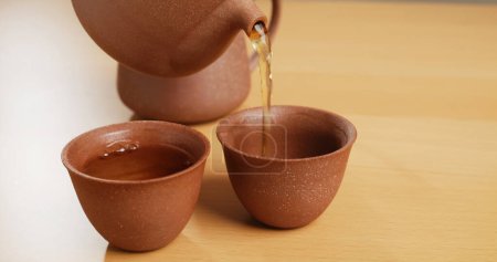 Photo for Traditional Chinese tea ceremony, pour tea into a cup - Royalty Free Image