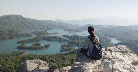 Photo for Woman sit on the rock and look at the scenery view - Royalty Free Image