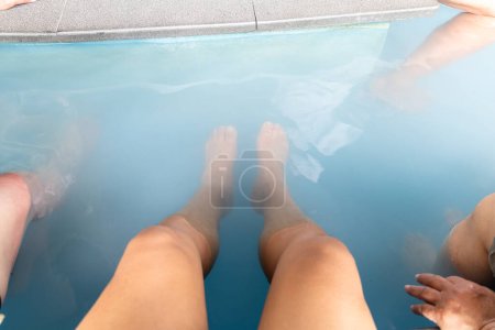 Photo for Man feet soak into the hot springs at natural onsen - Royalty Free Image