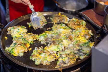 Photo for Cooking Taiwan famous Oyster omelette in local food store - Royalty Free Image
