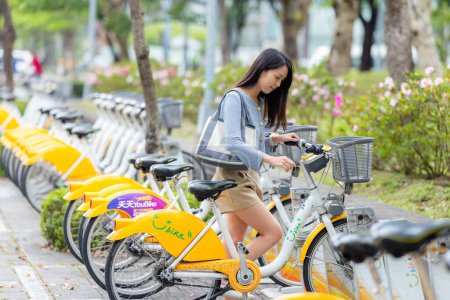 Photo for Taiwan - 06 April 2023: Woman using share bike in the city - Royalty Free Image