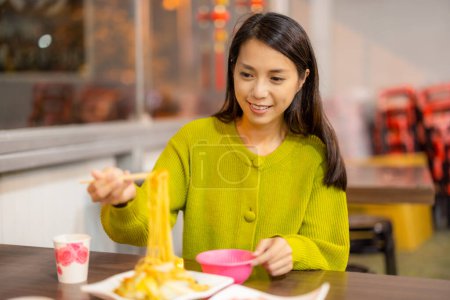 Photo for Woman enjoy the food at Taiwan local food store - Royalty Free Image