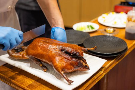 Photo for Chef prepare peking duck in restaurant for serving customer - Royalty Free Image