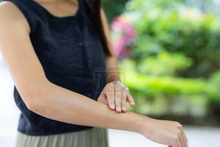 Photo for Woman apply sun block on hand - Royalty Free Image