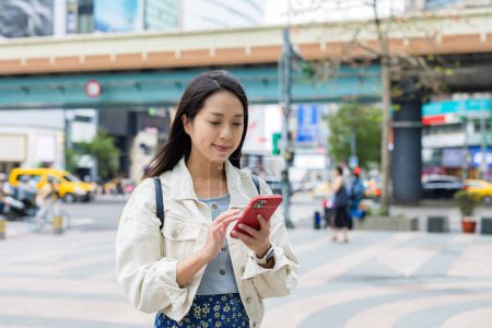 Photo for Woman use of mobile phone in city of Taipei - Royalty Free Image
