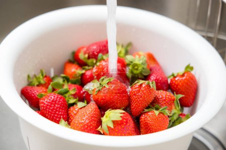 Photo for Wash strawberry in the kitchen - Royalty Free Image