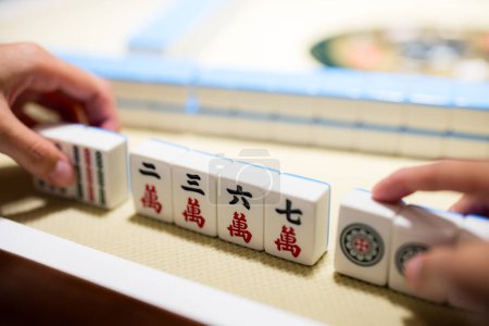 Playing Mahjong on the table