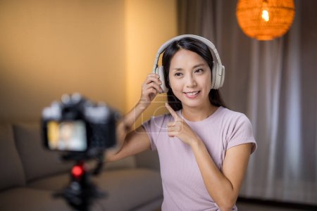 Photo for Woman use camera to take vlog at home - Royalty Free Image