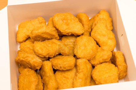 Photo for Golden deep fired chicken nugget in paper box - Royalty Free Image