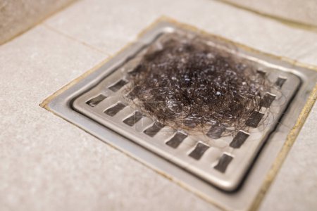 Photo for Hair loss after washing of the head in the drain hose in the shower - Royalty Free Image