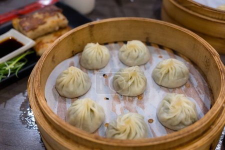 Photo for Steamed xiaolongbao served in a traditional steaming basket - Royalty Free Image