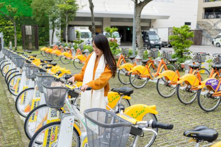Photo for Taiwan - 29 December 2023: Woman ride share bike in Taiwan - Royalty Free Image