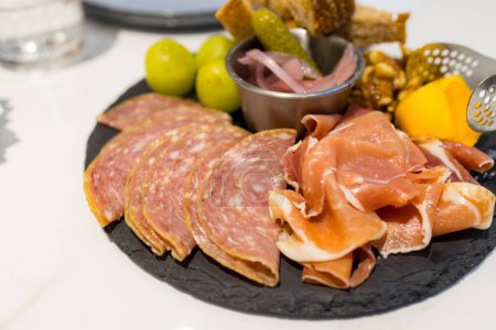 Photo for Appetizers cold cuts board with slice of ham and toast - Royalty Free Image