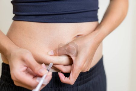 Photo for IVF and infertility treatment concept, woman have injection on her belly - Royalty Free Image