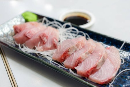 Slice of fish sashimi on plate