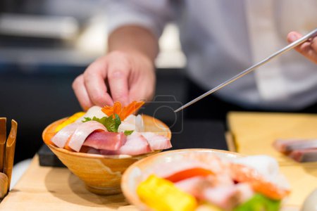 Téléchargez les photos : Chef japonais fait de bol de riz sashimi - en image libre de droit