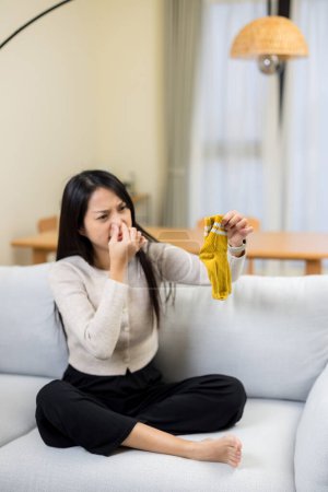 Photo for Woman hold with smells stinky sock - Royalty Free Image