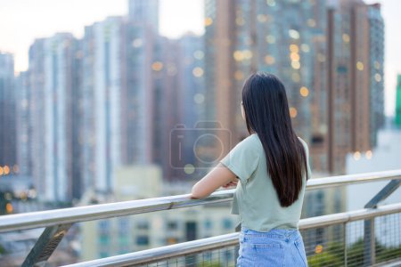 Woman look at the city in the evening