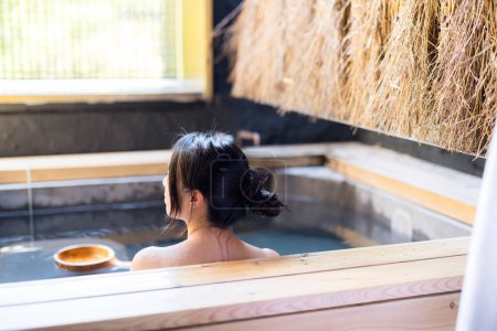 Photo for Asian Young woman relaxing in hot spring - Royalty Free Image