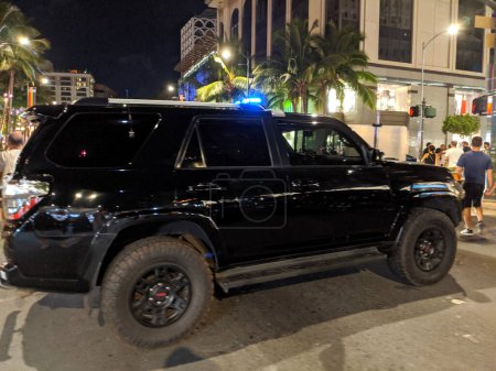 Photo for Honolulu - October 12, 2019:  Honolulu Police Department police car on street with lights flashing during evening event in Waikiki on Oahu, Hawaii. - Royalty Free Image