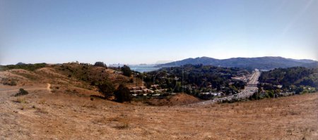 Photo for Dry Mountain side with Interstate Highway below running through Marin with city of San Francisco in the distance.  Panoramic. - Royalty Free Image