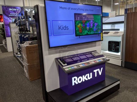 Photo for Honolulu - November 7, 2020: Roku TV TCL Sharp Hisense on display at Best Buy. The Roku Streaming Player, or simply Roku, is a series of streaming players manufactured by Roku, Inc. Roku partners provide over-the-top content in the form of channels. - Royalty Free Image