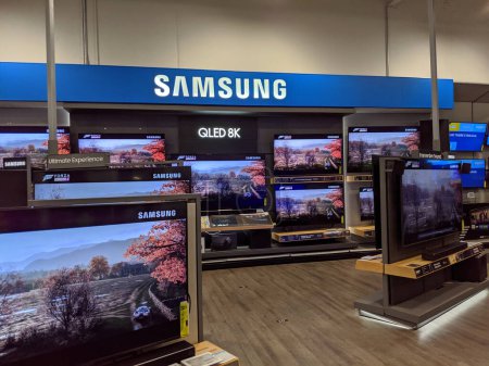 Photo for Honolulu -  November 2 2019:   Samsung Logo and QLED 8K TV inside Best Buy Store.  Samsung is a South Korean multinational conglomerate headquartered in Samsung Town, Seoul. It comprises numerous affiliated businesses, most of them united under the S - Royalty Free Image