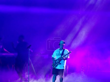 Photo for Honolulu - November 8, 2018:  Bruno Mars plays guitar on stage during Concert in Hawaii at the Aloha Stadium. - Royalty Free Image