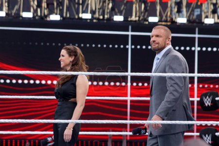 Photo for Santa Clara, California - March 29, 2015: Triple H and Stephanie McMahon smile in the middle of the ring as they celebrate at Wrestlemania 31 at the Levi's Stadium. - Royalty Free Image