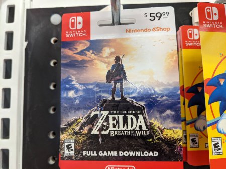 Téléchargez les photos : Honolulu - September 28, 2021: Nintendo Switch digital game The Legend of Zela Breath of the Wild Full Game Download cards for sell on Display inside Target store. Nintendo Switch is designed to go wherever you do, transforming from home console to p - en image libre de droit
