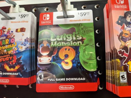 Téléchargez les photos : Honolulu - September 28, 2021: Nintendo Switch digital games Luigi's Mansion 3 Full Game Download cards for sell on Display inside Target store. Nintendo Switch is designed to go wherever you do, transforming from home console to portable system in a - en image libre de droit