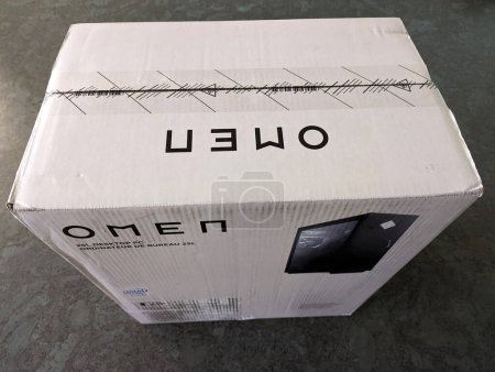 Photo for Honolulu - January 27, 2022: The OMEN 25L Desktop PC with Intel inside is packaged in a large white box, ready for purchase or shipment. The front of the box features the OMEN logo and product information. - Royalty Free Image