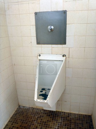 Photo for Honolulu - February 7, 2012: An unfortunate sight to see...an old, dirty urinal in a public restroom at Sand Island Park, Oahu. - Royalty Free Image
