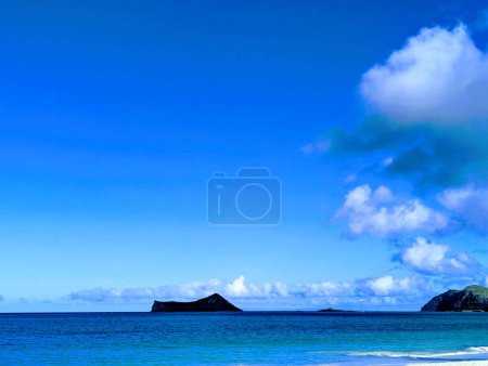 Photo for Escape to paradise with a breathtaking view of Rabbit and Rock Islands in Waimanalo Bay on Oahu, Hawaii. Relax on the stunning sandy beach and soak up the beauty of this tropical oasis, surrounded by crystal clear waters and stunning natural wonders. - Royalty Free Image