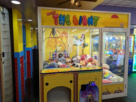 Photo for Honolulu - March 16, 2022: The giant claw machine at Fun Factory in Honolulu, Hawaii is a popular attraction for people of all ages. Kids love trying to win the stuffed animals inside, while adults enjoy the challenge of trying to grab the perfect pr - Royalty Free Image