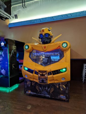 Foto de Honolulu, Hawaii - 28 de marzo de 2022: Estatua del robot transformador de abejas amarillas en una máquina de arcade en una sala de arcade. - Imagen libre de derechos