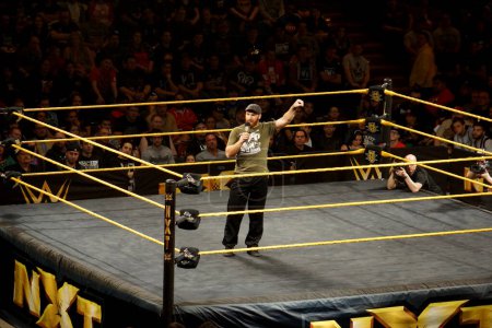Photo for San Jose, California - March 27, 2015: NXT Wrestle Sami Zayn pumps up crowd as he talks into microphone in ring to crowd at the San Jose Event Center. - Royalty Free Image