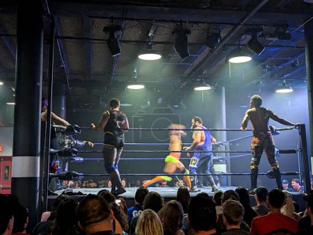 Photo for Honolulu, HI - December 22, 2022: Bitter Sweet Love defend their belts against The Nightmarchers and The Modern Day Savages in a Triple Threat Tag Team Table Elimination Match. - Royalty Free Image